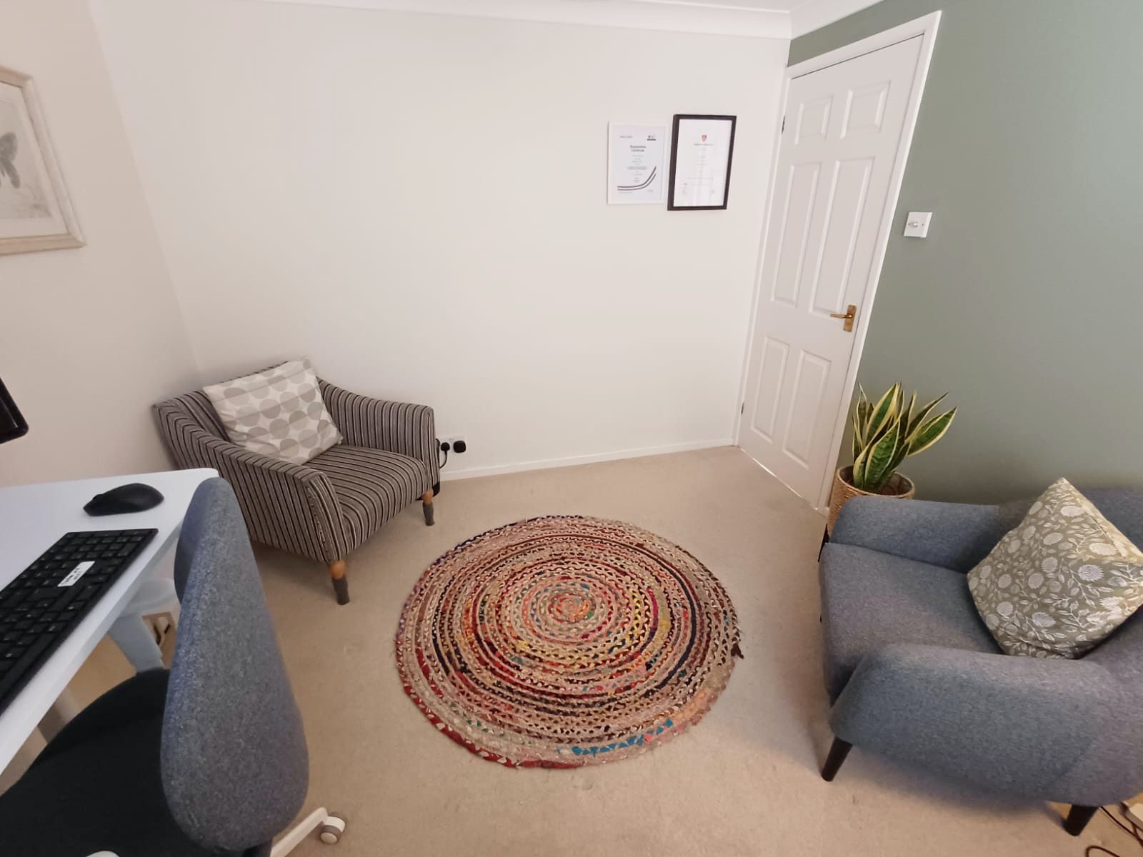 The counselling room, with soft seating, a rug and natural light
